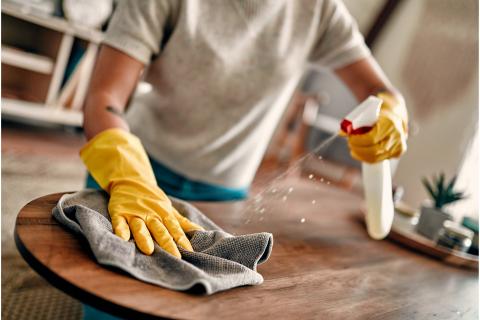 Unidentified person cleaning table top