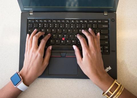 Hands on a laptop keyboard