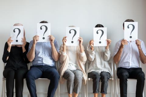 Line of people with question marks in front of face