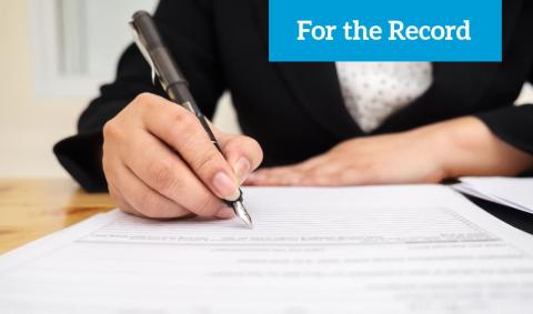 Woman signing a document