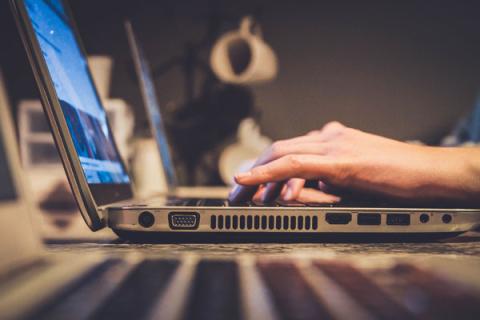 Hands on laptop keyboard