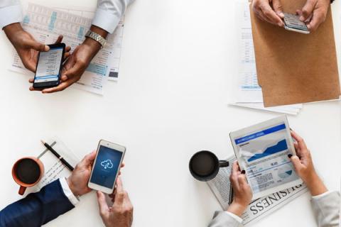 People in a meeting with devices