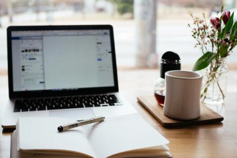 Laptop and book on desk