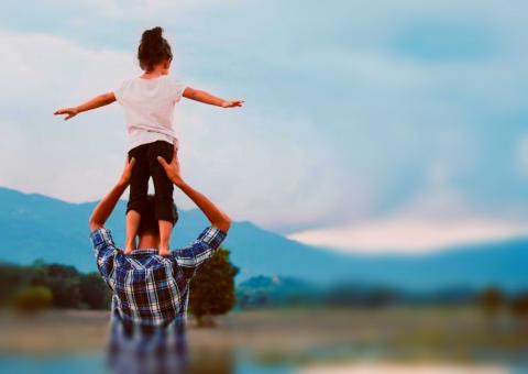 Kid on adult's shoulders